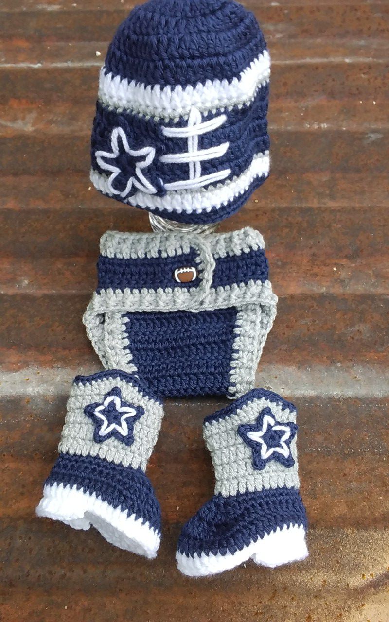 Crochet baby in navy blue outfit.