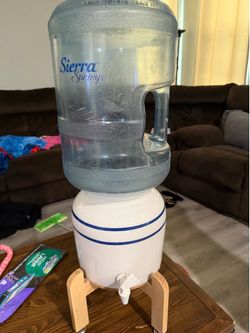 Water dispensary with 9 jugs and stand included