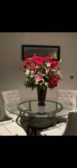 Glass dining table with four chairs.