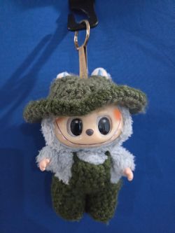 Labubu vinyl/plush (The Monster series) dressed in a handmade crochet bucket hat with matching overalls