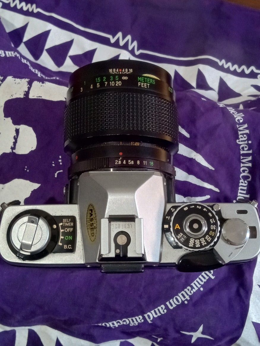 Minolta logo and Vivitar Lens