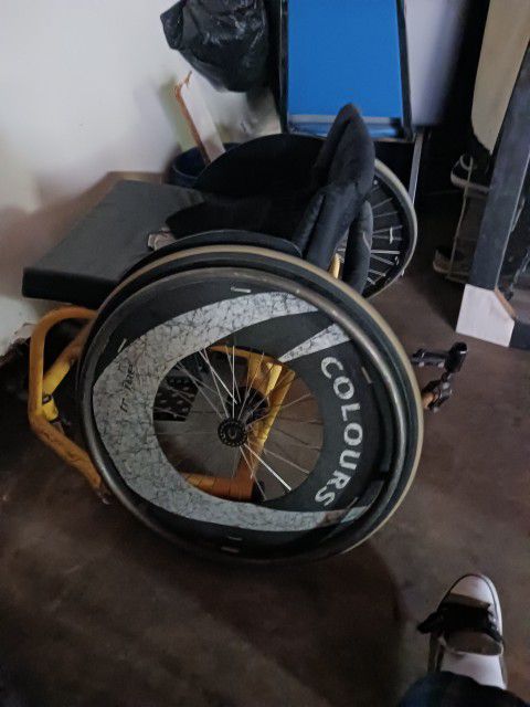 Wheel Chair And 2 Hockey Sticks 