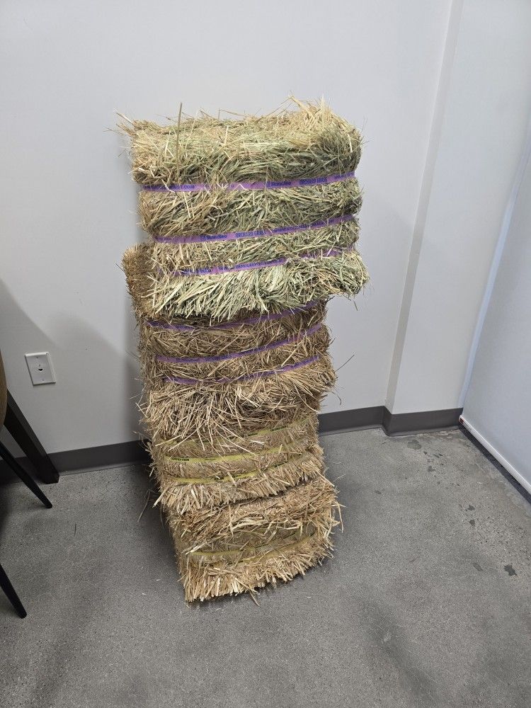 Two Bales Of Hay And Two Bales Of Straw