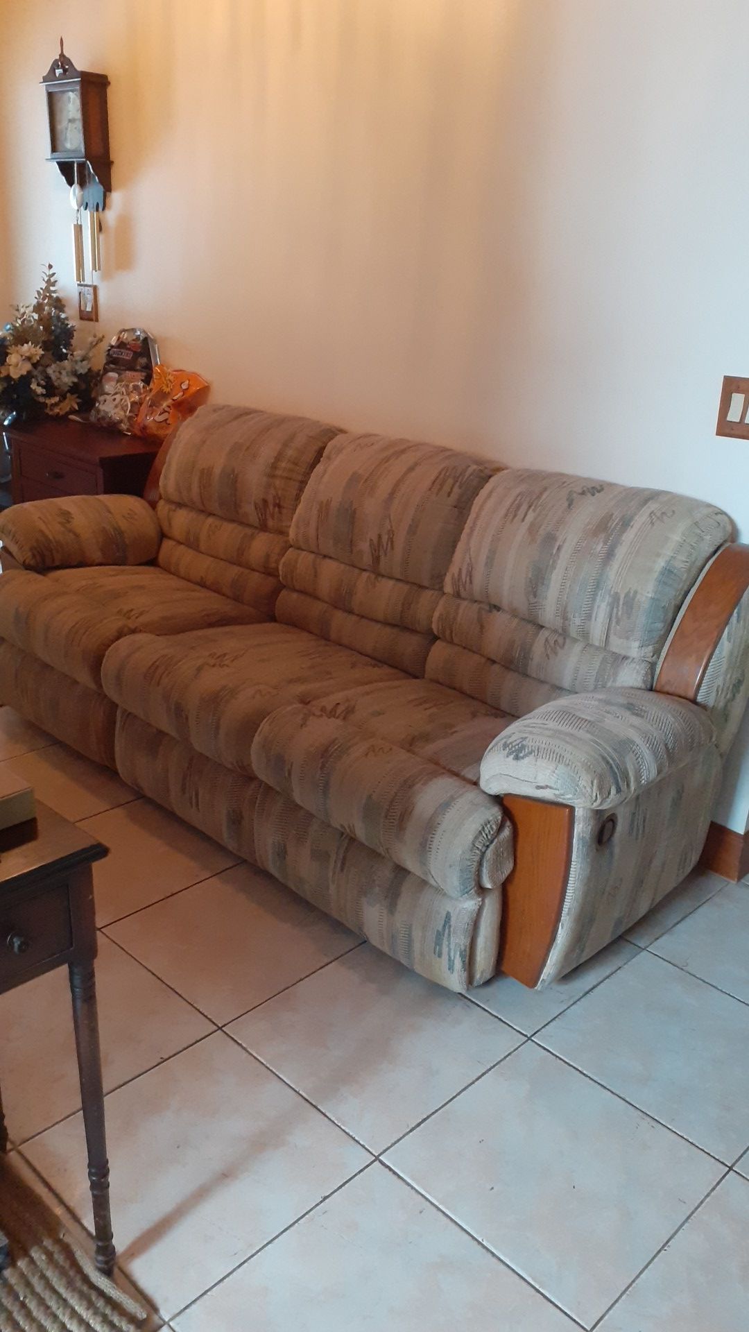 Couch, approximatemly 90 inches long, 39 inches deep and 39 inches tall. Has two recliners in couch.