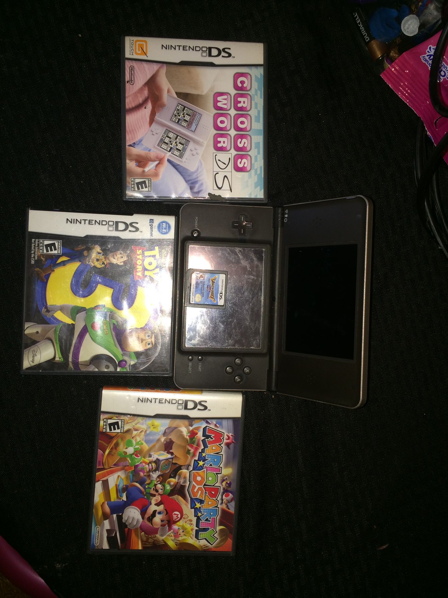 NINTENDO DS XL AND FOUR GAMES MARIO PARTY TOY STORY 3 CROSS WORD AND DRAGON QUEST