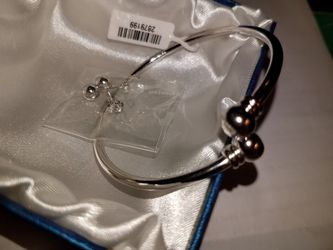 Bypass bangle (7.00) and stud earrings in silver tone.