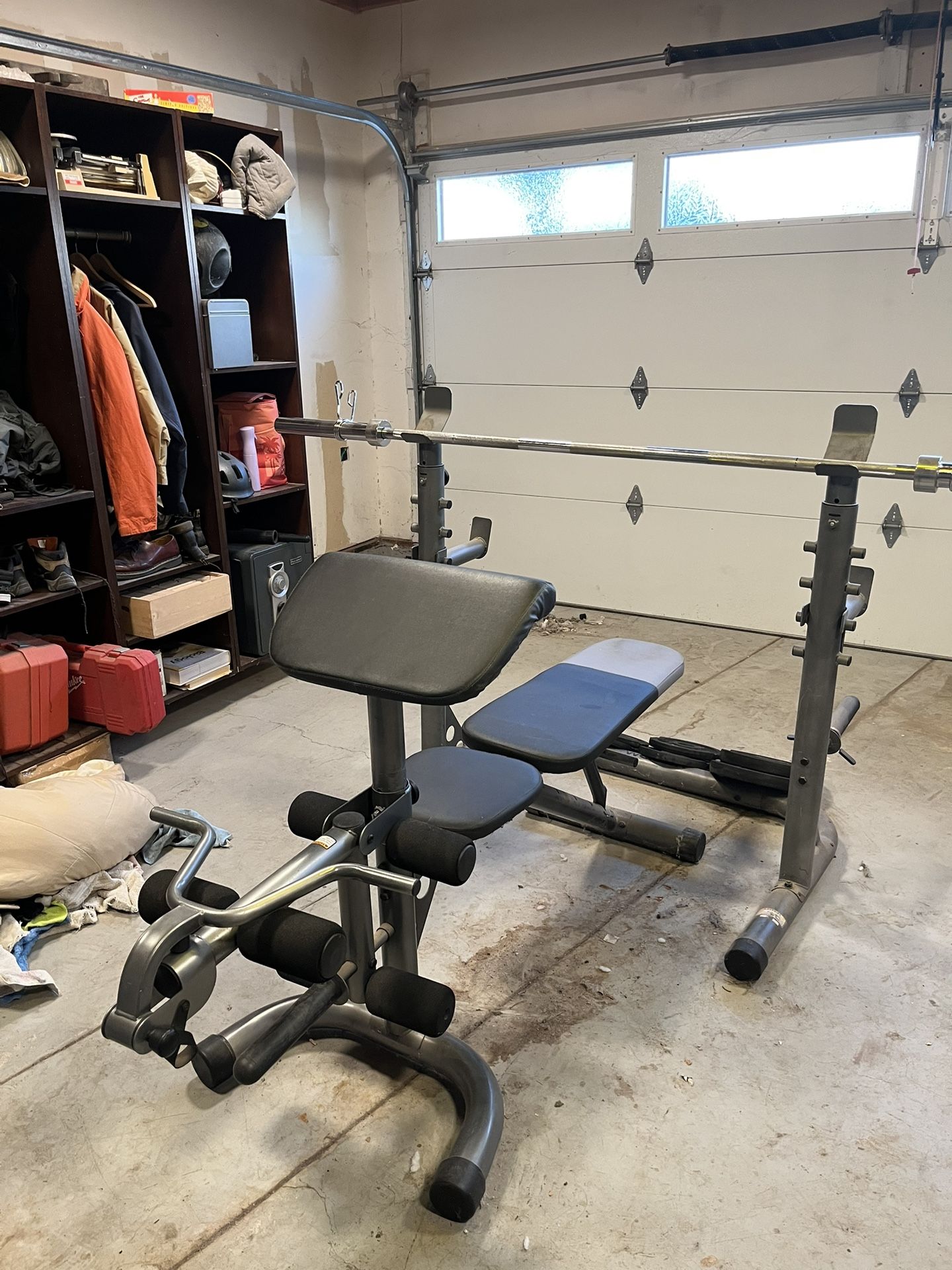 Olympic Bench Press, Leg Extension, Preacher Curl, Olympic Bar, and Weights