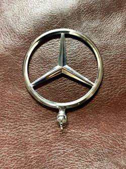 vintage Mercedes-Benz round grille badge / hood star emblem with a chrome-finished three-pointed star inside a circular ring