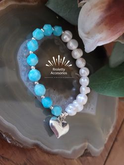 Sterling Silver 925 elastic Bracelet with a Puffy Heart Charm and white freshwater Pearls and Baby Blue crystal beads.