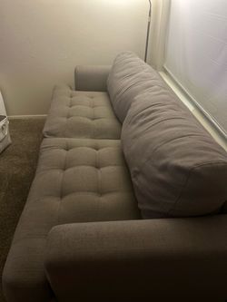 Clean grey tufted sofa