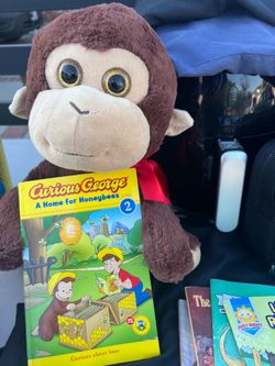 Curious Jorge stuffed animal with book