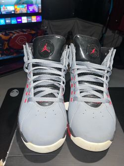 Black mid-top Jordan Dub Zero sneakers with embossed graphic leather panels, Jumpman branding, lace-up closure, and a speckled white midsole. Visible 