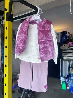 Un CD, pantalón y blusa y saquito para niña