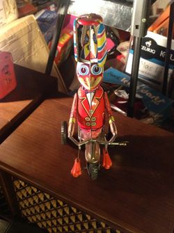 Vintage tin wind up bike riding duck