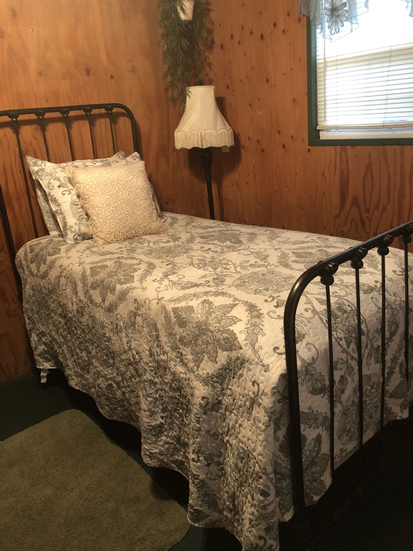 Twin iron bed and lamp