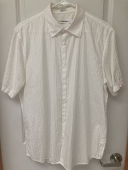 Calvin Klein white short-sleeve button-up shirt with a subtle tone-on-tone stripe pattern and spread collar. Men size medium.