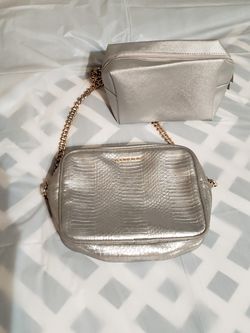 victoria secret silver purse with gold colored chain and