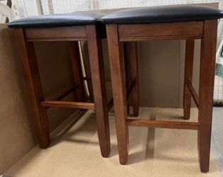 Pair of 24" (h) 16x16” wooden bar stools with faux‑leather upholstered black seats