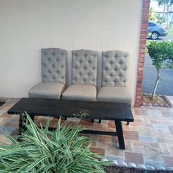 ACACIA TRESTLE BENCH AND THREE MATCHING CHAIRS.