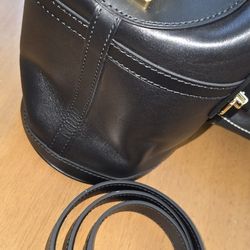 This is a Louis Vuitton Calfskin Duffle Bag in black leather with gold-tone hardware. 