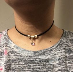 Black choker necklace with golden beads and crystal charm