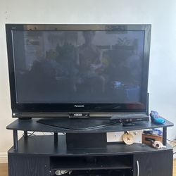 Panasonic Viera television W/ black media console. 