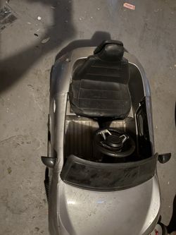 Kids sit in Mazda mx-5 remote control car