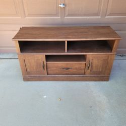ENTERTAINMENT CENTER BROWN IN COLOR. 2 DOOR , 1 DRAWER WITH 2 OPEN SHELVES BROWN IN COLOR. PRESSBOARD MATERIAL. FROM A PET FREE HOME. $25 