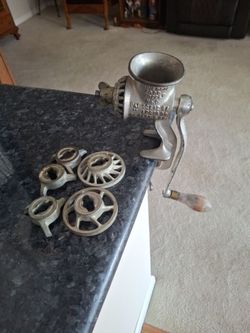 Old metal meat grinder with different size grinders