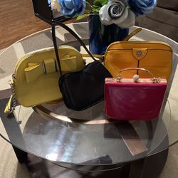 4 Purses, Two Yellow Ones, black one, Pink One.