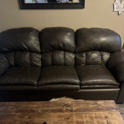 Brown faux leather couch with pullout bed.