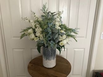 Beautiful faux flower arrangement in a stone vase