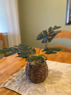 Faux Monstera plant in Seagrass pot. 12 inch tall. Good condition . Bo Ho / farmhouse/ cottage.