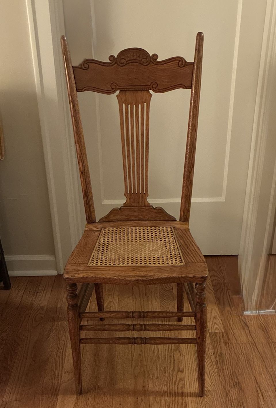 Ohlly crafted antique press back chair with cane seat.