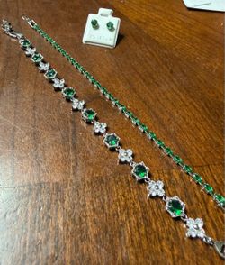 Emerald green earrings sterling silver with 2 emerald green tennis bracelets that are white gold plated.