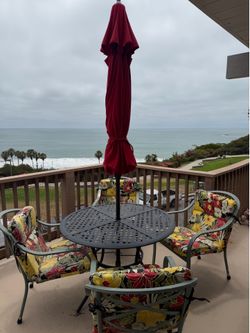 Patio table w/4 chairs, cushions, and umbrella all included