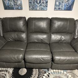 Calderwell Power Reclining Sofa And Love Seat Set. Gray Leather 