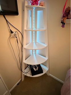 white corner shelf with a modern curved design