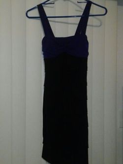 Cute form fitting black dress with purple top portion size small