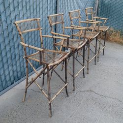 four very solid metal chairs with bamboo finishes