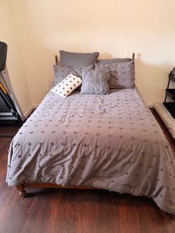 Full size bed frame with box spring, mattress, mattress topper, and comforter set