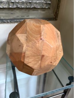 Decorative hand- carved faceted wooden sphere with a geometric polyhedron design 9”x9”