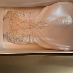 DAVIDS BRIDAL. This is a white bridal gown or wedding dress featuring a beaded bodice.