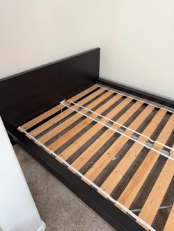 Queen Bed With Dark Brown Color. From Ikea.