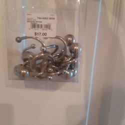 NEVER USED, STAINLESS STEEL CURTAIN HOLDERS  (12PIECES)