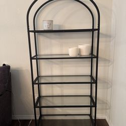 Arched iron bookshelf with glass panels