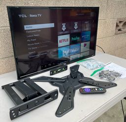 smart TCL Roku TV with a wall mount kit.