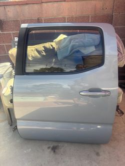 LEFT DRIVER SIDE REAR DOOR 2019 TOYOTA TACOMA (LIGHT BLUE) WITH HINGES.