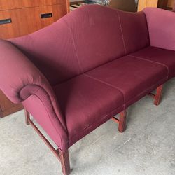 Burgundy polyester-upholstered loveseat, seats up to 3 people.