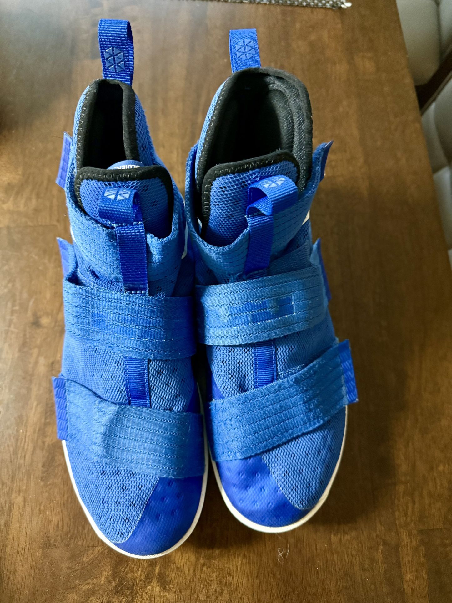 Blue Cross and white Nike basketball shoe size 10.5